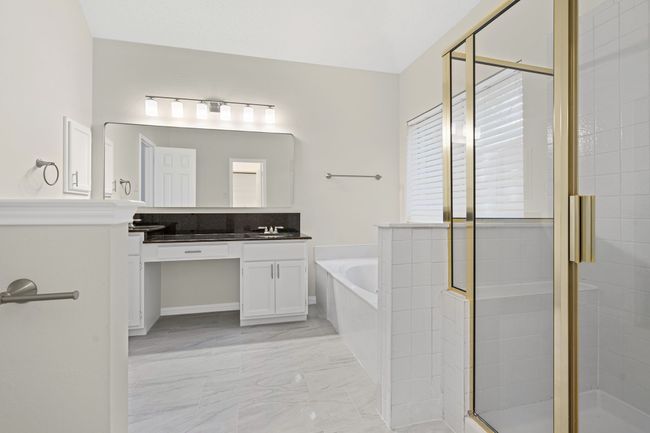 Primary bathoom has updated mirror, lighting and fixtures | Image 14