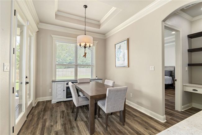 Enjoy a bright breakfast nook filled with natural light from large windows and direct access to the backyard through a convenient door. | Image 14