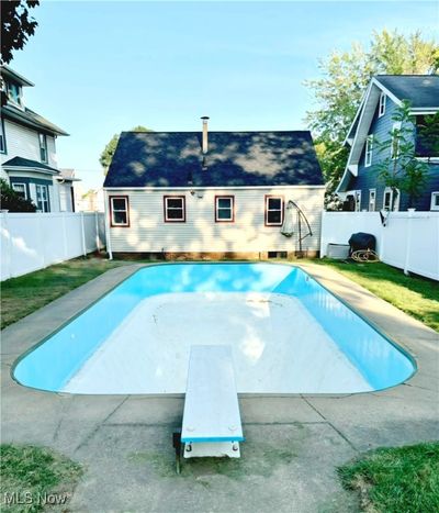 View of pool featuring a diving board | Image 2