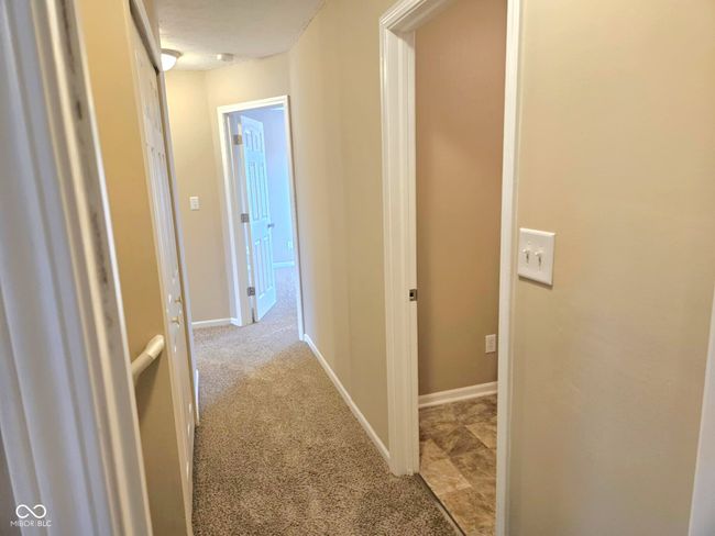 hallway with baseboards and carpet | Image 26