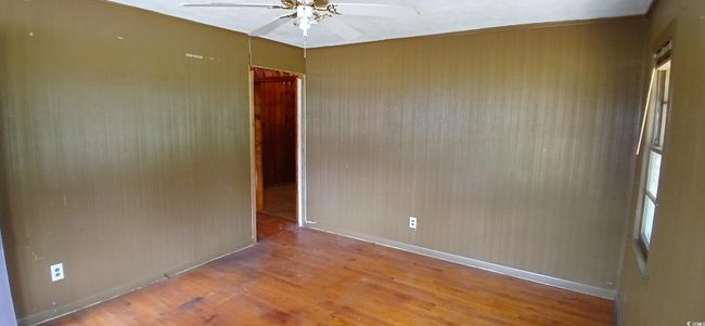 room with ceiling fan and wood finished floors | Image 15