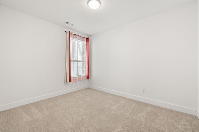 Spare room featuring baseboards, light colored carpet, and visible vents | Image 14