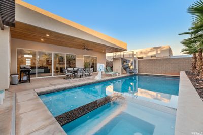 Pool at dusk with a patio | Image 3