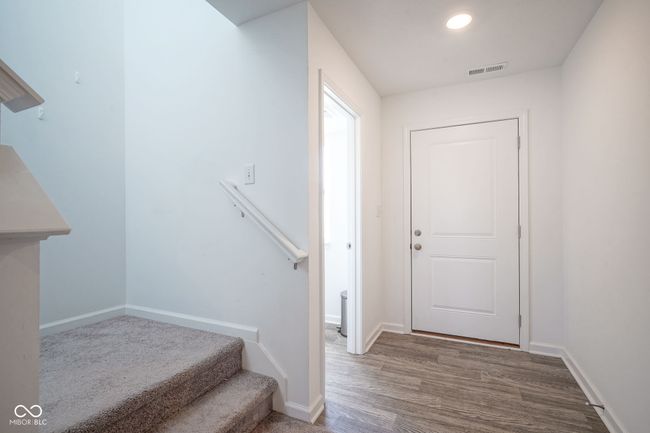 entrance foyer featuring wood finished floors and stairway | Image 17