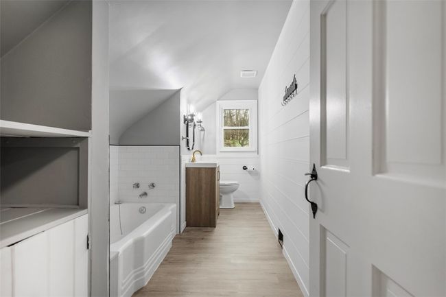 The hall bath has been completely updated in the original style of the home. | Image 26
