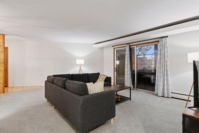 The balcony transitioned into a 3-season porch area because the “EZ Screen” window system keeps the area clean and out of windy wet weather. | Image 21