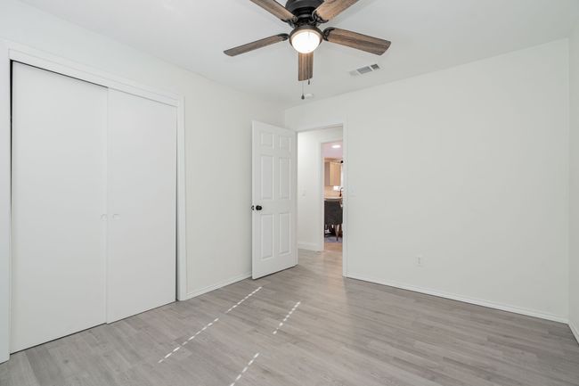 Unfurnished bedroom featuring light wood-style flooring, a closet, and ceiling fan | Image 18