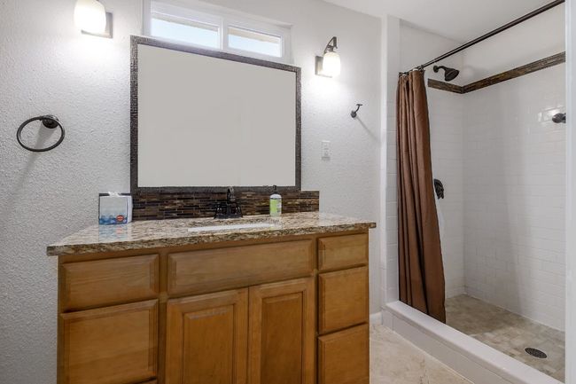 Bathroom with a stall shower and vanity | Image 32