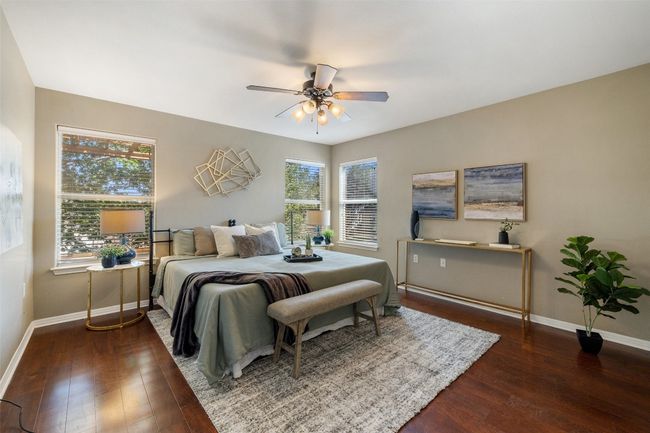 Bedroom with baseboards, wood-type flooring, and multiple windows | Image 18