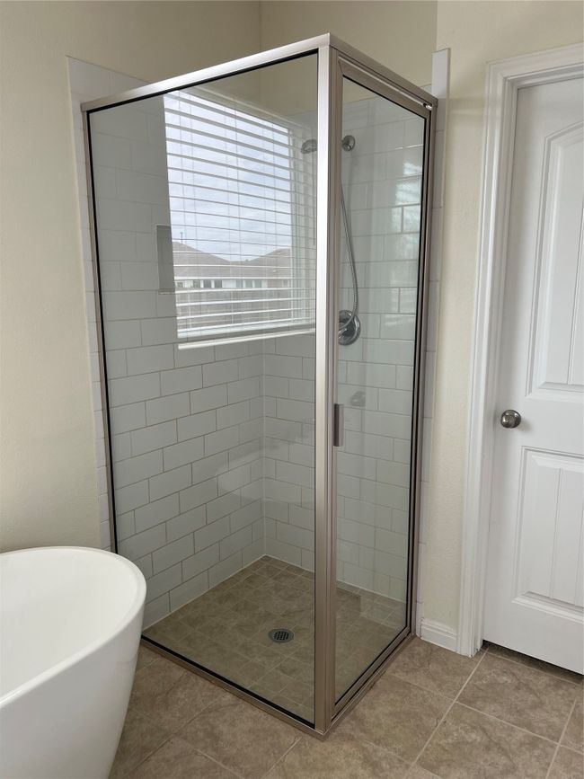 Upgraded Primary Bathroom featuring Glass-enclosed shower and a freestanding tub. | Image 11