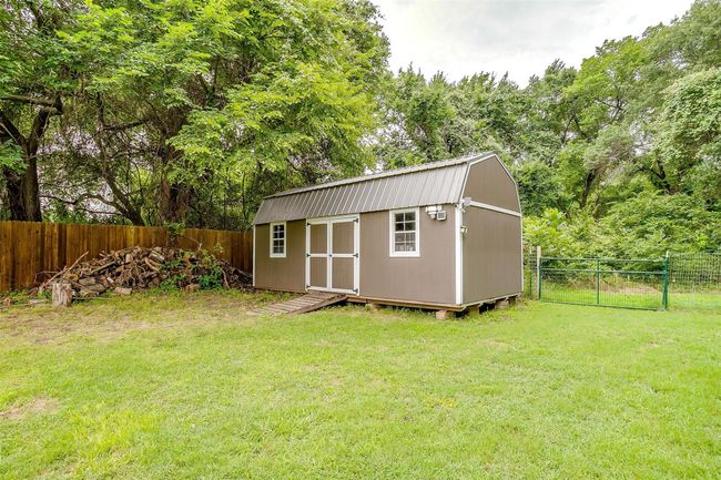 View of shed with a fenced backyard | Image 35