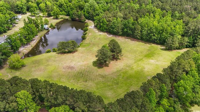 Aerial view of property's location featuring a nearby body of water and a forest | Image 39