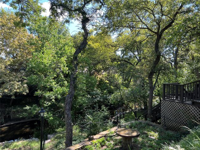 View of yard featuring a wooden deck and a forest view | Image 29