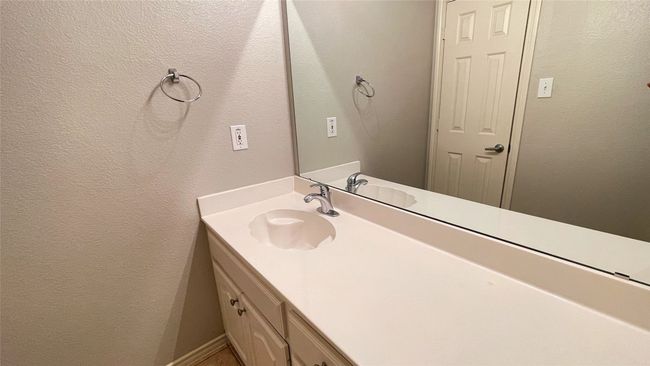 Bathroom featuring vanity and a textured wall | Image 28
