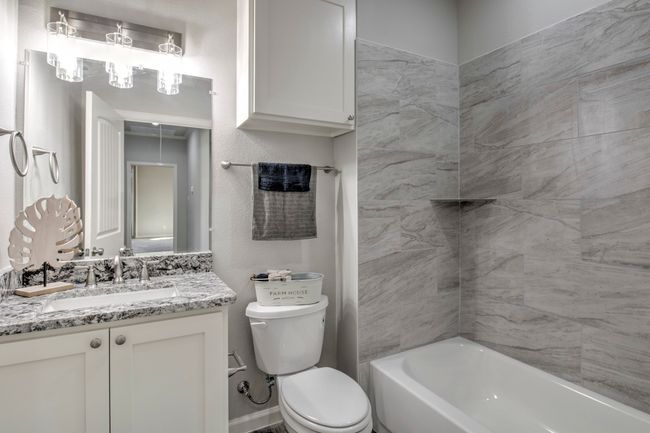 Full bath featuring vanity and bathing tub / shower combination | Image 12