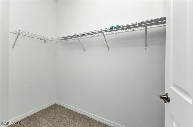Walk in closet featuring carpet floors | Image 38
