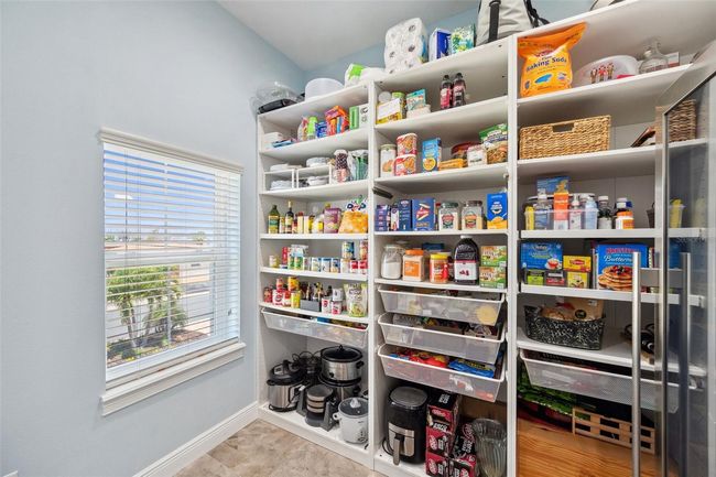 The pantry/laundry room on 2nd floor offers lots of shelving - with multiple pull-out drawers and shelves. | Image 40