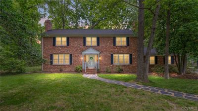 Twilight photo of the exterior front of the home view to the 7X4 covered front porch | Image 1