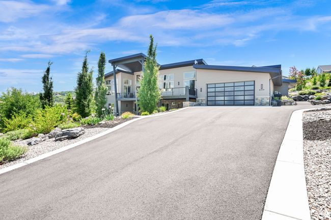 Contemporary house featuring a garage and driveway | Image 101