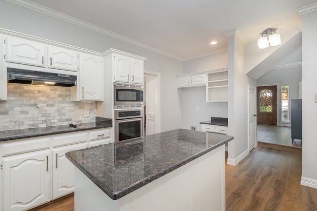 Kitchen with stainless appliances, under cabinet range hood, under cabinet lighting | Image 10