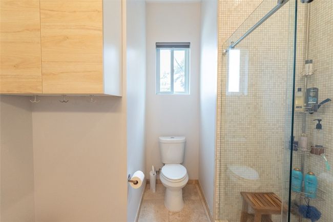 Bathroom featuring a shower stall and tile patterned floors | Image 18