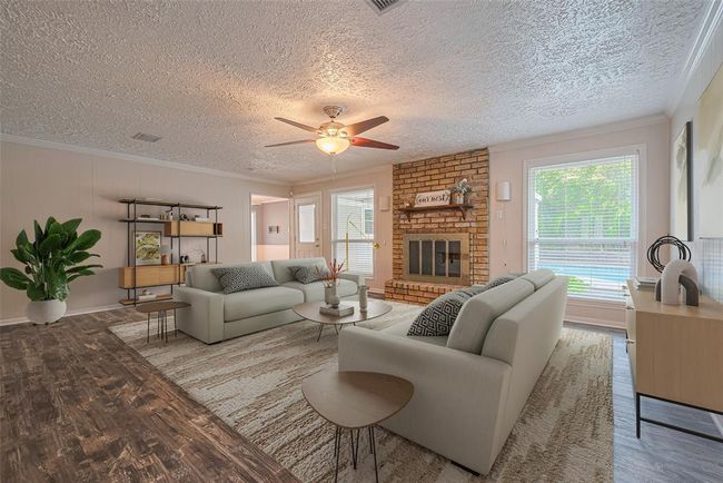 Virtually staged den is showcases the fireplace, wood look laminate flooring, fresh paint and offers lovely views of the backyard. | Image 5