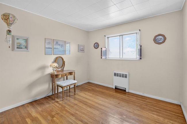 Empty room with radiator and light wood-style floors | Image 12