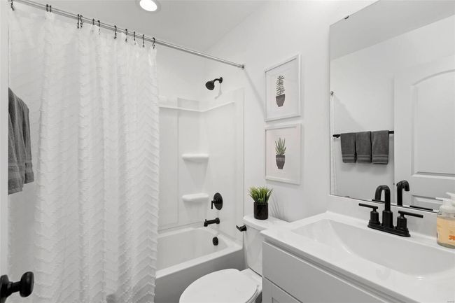 Full bathroom featuring vanity, toilet, and shower / bath combo with shower curtain | Image 11