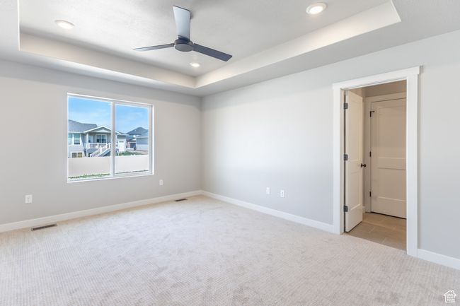 Unfurnished room with a tray ceiling, light carpet, ceiling fan, baseboards, and recessed lighting | Image 12