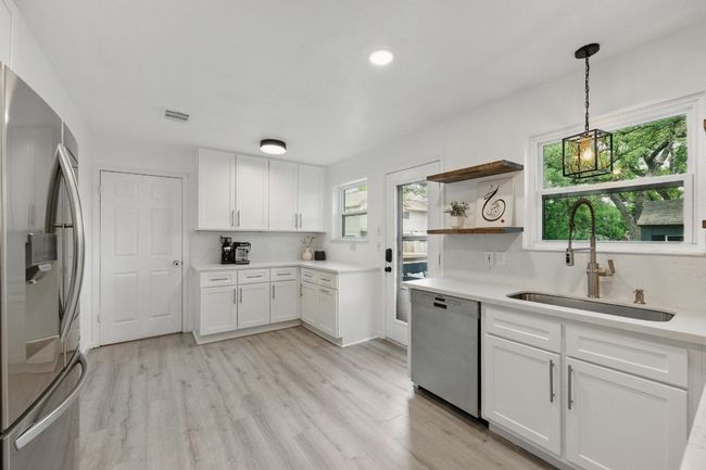 Sleek quartz countertops and recent cabinets offer a modern, stylish feel to this chef-inspired kitchen. | Image 10