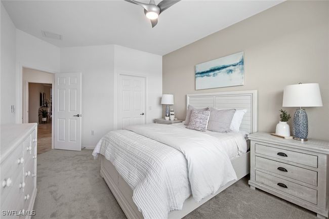 Bedroom featuring a closet, a ceiling fan, light colored carpet, and visible vents | Image 30
