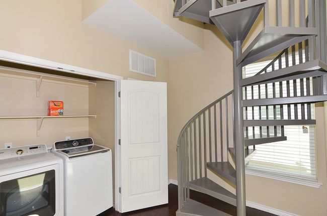 Laundry room on 3rd level with the bedrooms; Sprial stairs lead to the rooftop patio | Image 20