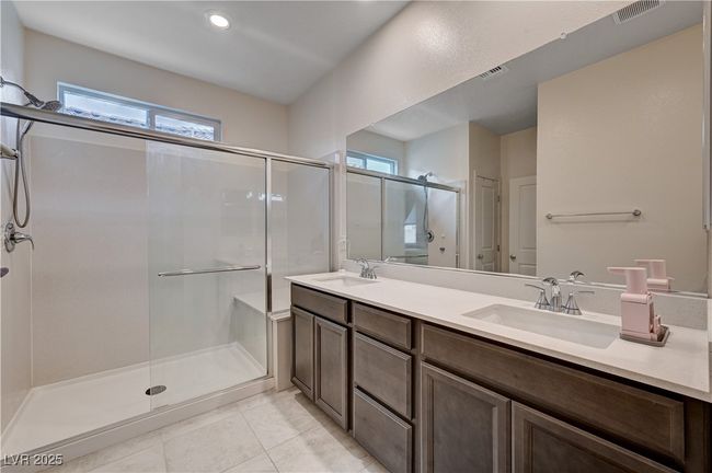 Full bathroom with a stall shower, double vanity, tile patterned flooring, and recessed lighting | Image 23