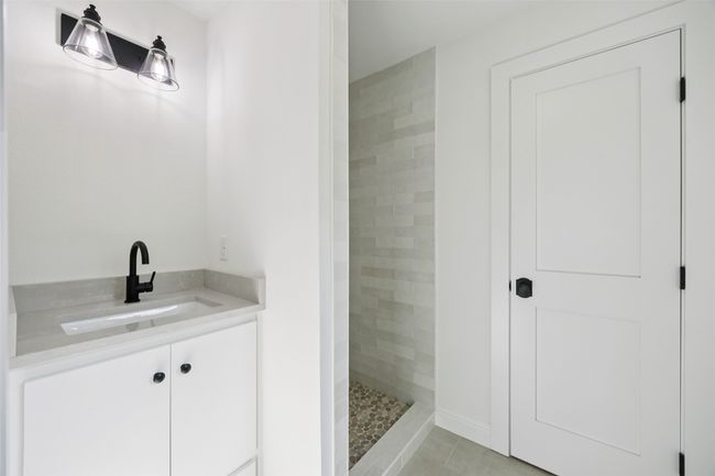 Full bath with a tile shower, tile patterned floors, and vanity | Image 15