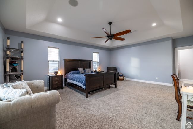 Bedroom with a tray ceiling, recessed lighting, carpet floors, and ceiling fan | Image 28