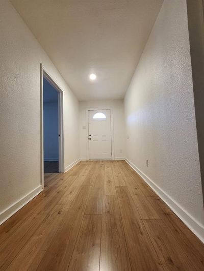 Unfurnished room featuring light wood-type flooring | Image 2