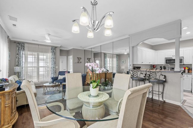 Dining room featuring a ceiling fan, crown molding, healthy amount of natural light, dark wood-type flooring, and recessed lighting | Image 13