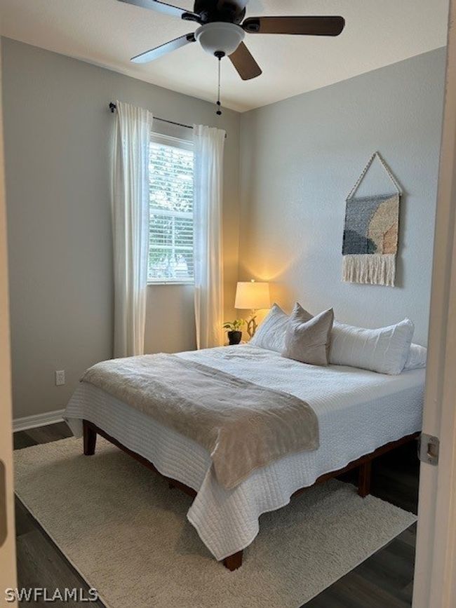 Bedroom featuring dark wood-type flooring and ceiling fan | Image 24