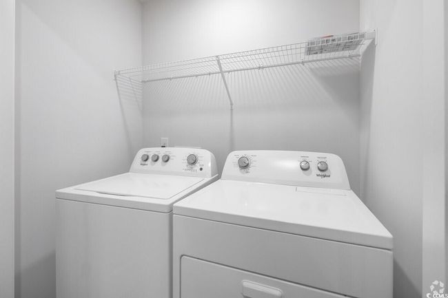 Laundry area featuring washing machine and dryer | Image 15