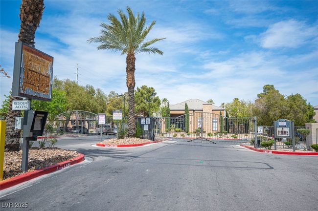 View of street featuring a gated entry, curbs, and a gate | Image 37