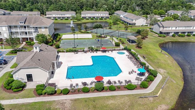 Aerial perspective of suburban area with a pool and a large body of water | Image 28