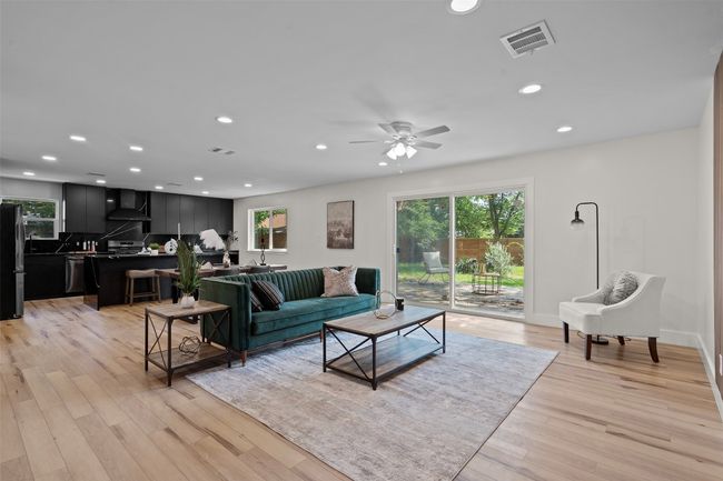 Living room with recessed lighting, light wood-style floors, a ceiling fan, and baseboards | Image 14