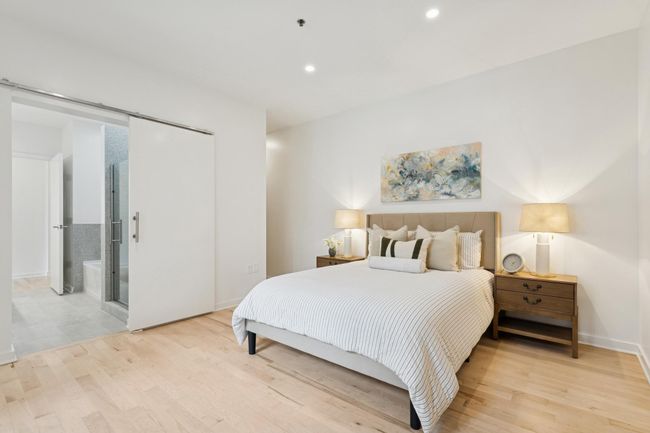 The spacious main-level primary suite is a true retreat, complete with a private en-suite bath and walk-in closet. | Image 17