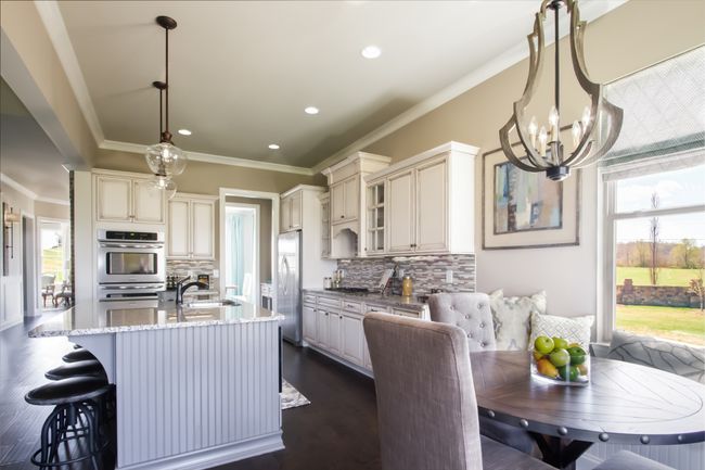 The breakfast room overlooks the back yard and includes banquette seating. | Image 24