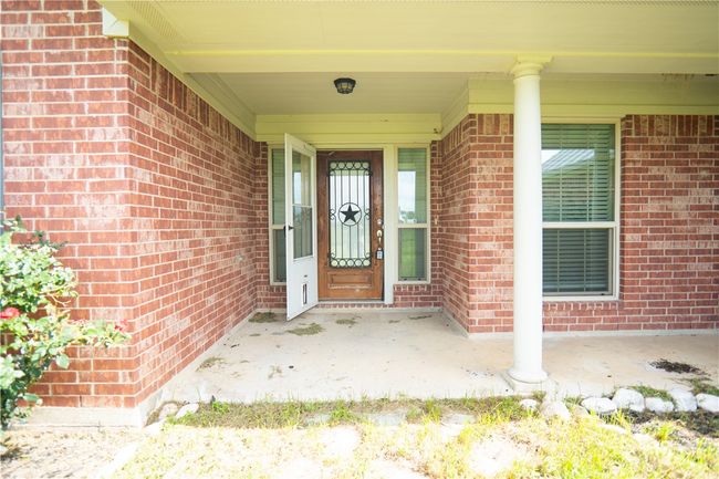 Doorway to property featuring brick siding | Image 16