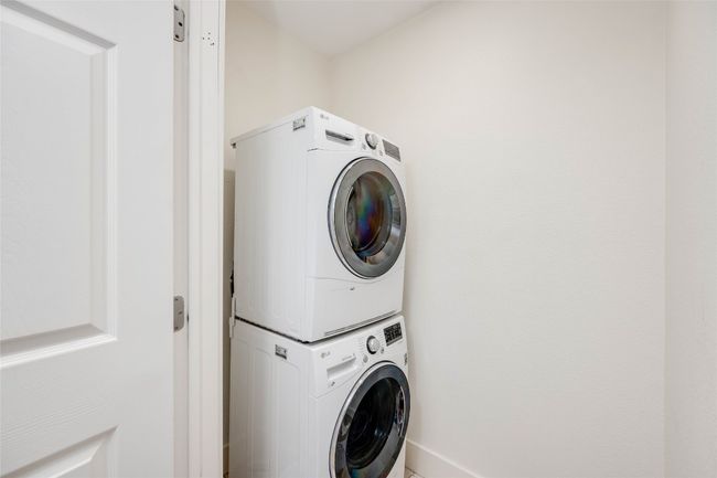 Washroom featuring stacked washer / dryer and baseboards | Image 17