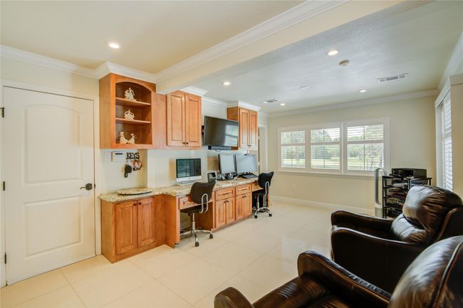 The study features convenient built-ins and plenty of natural light, creating an ideal space for work or relaxation. | Image 13