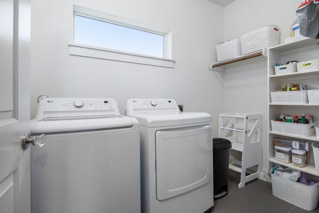 Laundry room with ample shelving for extra storage. | Image 26