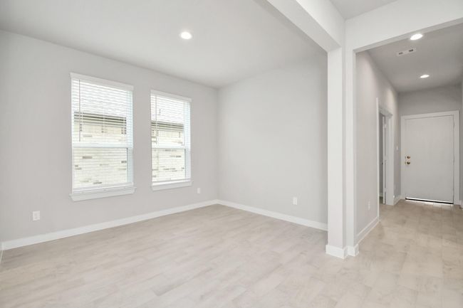 Create lasting memories with your family and friends at the dining table! This expansive dining room showcases sophisticated flooring, custom paint, and seamlessly connects to the family room and kitchen, providing an open and inviting atmosphere | Image 10