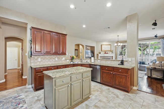 Kitchen with dishwasher, arched walkways, open floor plan, a sink, and recessed lighting | Image 10